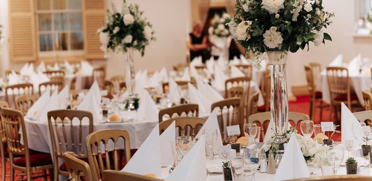 Reception tables set with white florals