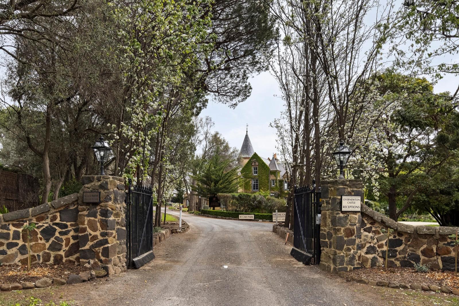 Stone entrance gates and tree-lined driveway