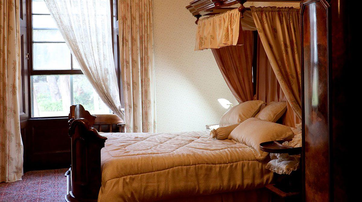 Restored bedroom with a canopy bed